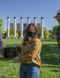 Jim Spain presents Hesburgh scholarship plaque to Maggie Courtney while William Horner stands by.