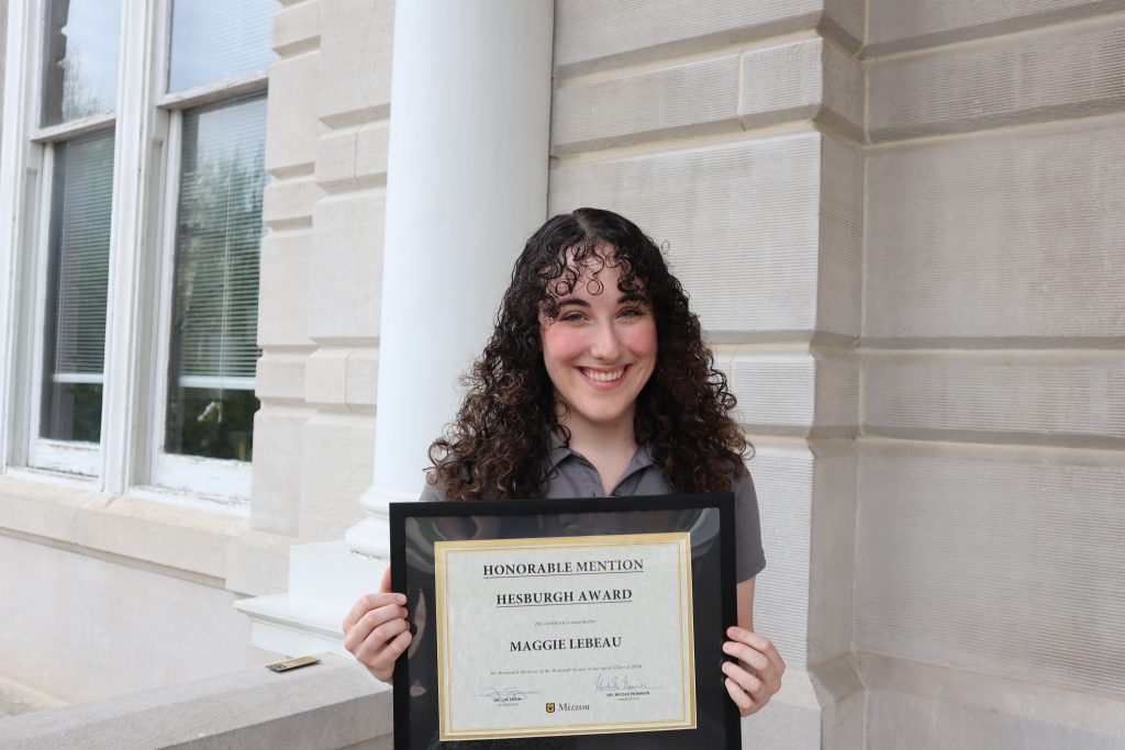 Maggie Lebeau holding certificate.