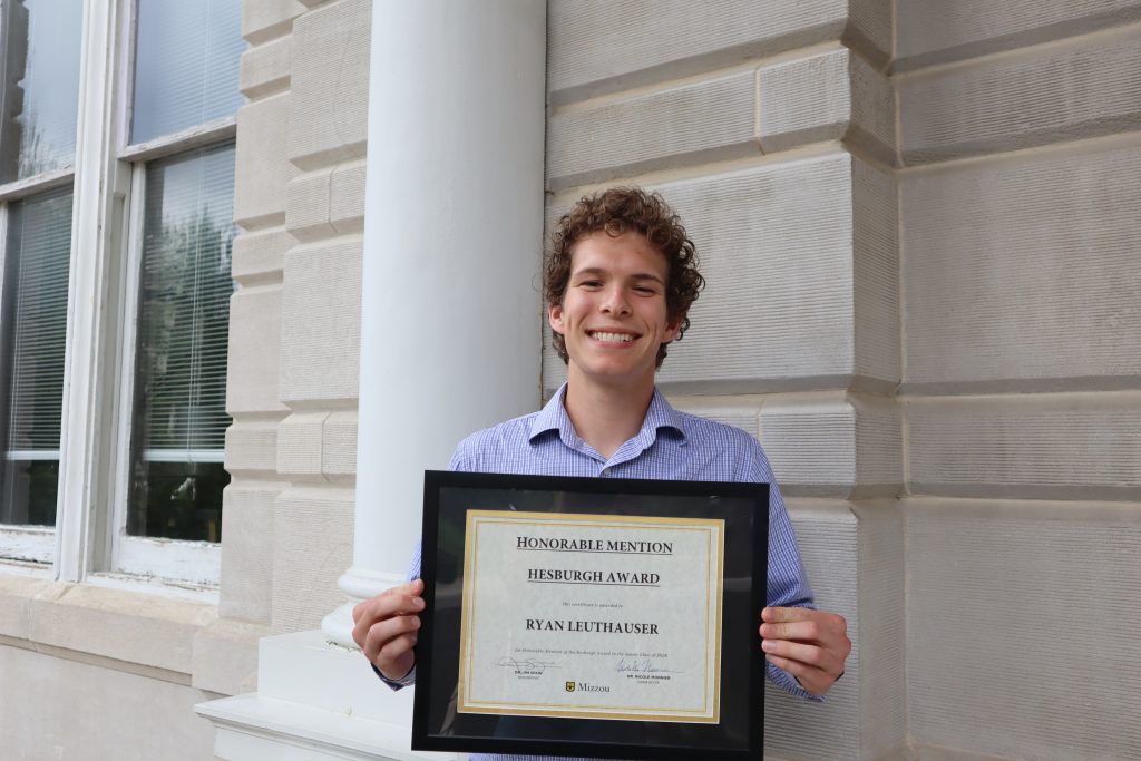 Ryan Leuthauser holding certificate.