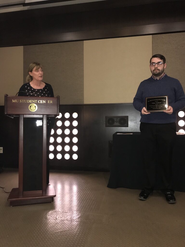 Ethan Anderson receiving award